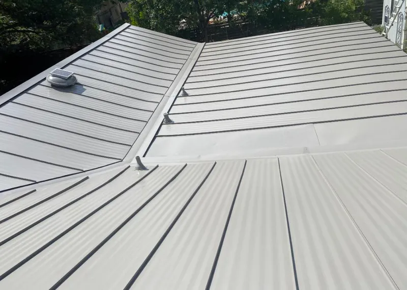Solar attic fan installed on a metal roof for Roof Ventilation in White
